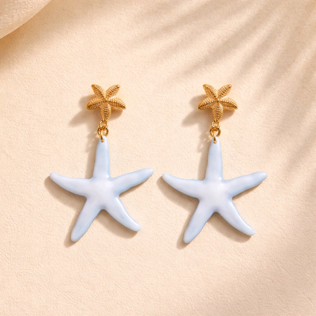 Pendientes de estrella de mar en acrílico azul glaciar y oro, bisutería de diseño mediterráneo antialérgica colección Riviera.