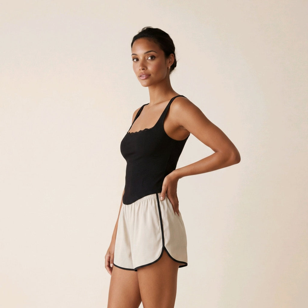 Top corsé negro elegante de algodón con bajo en pico y detalle de encaje Livia de Muzetto 
